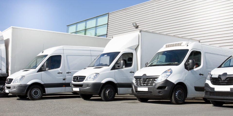 delivery-white-vans-service-van-trucks-cars-front-entrance-warehouse-distribution-logistic-society Pre-Departure Books
